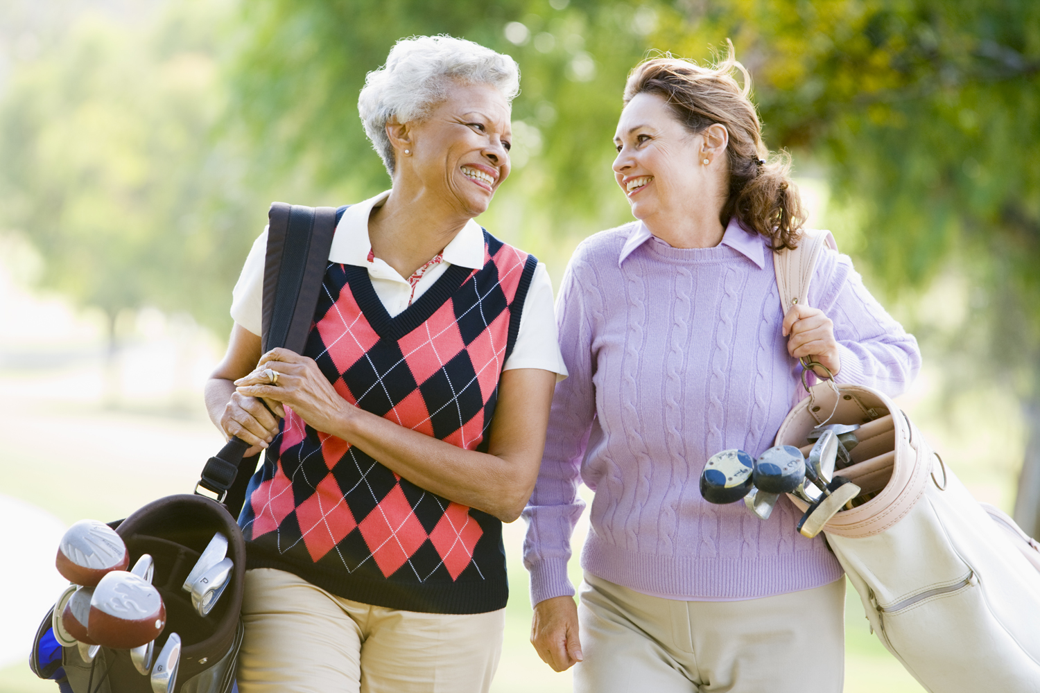Female Friends Enjoying A Game Of Golf