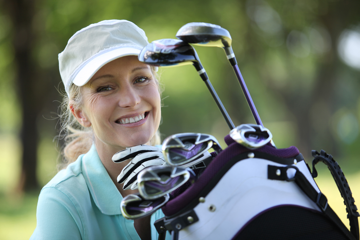 woman with a bag full of golf clubs